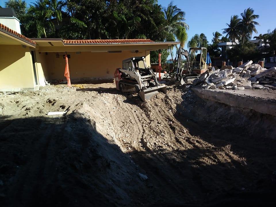 An excavation and demolition site with heavy machinery by Dade Wrecking Demolition LLC in Miami, FL.
