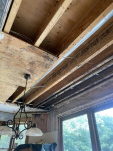 Exposed ceiling joists and subfloor showing water damage during remediation by ServiceMaster DSI in Maple Grove, MN.