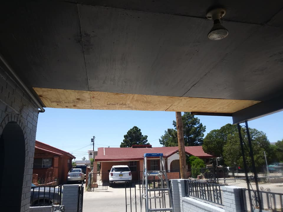 An exposed plywood ceiling under a porch, showing interior water damage repair work by DryTech in El Paso, TX.