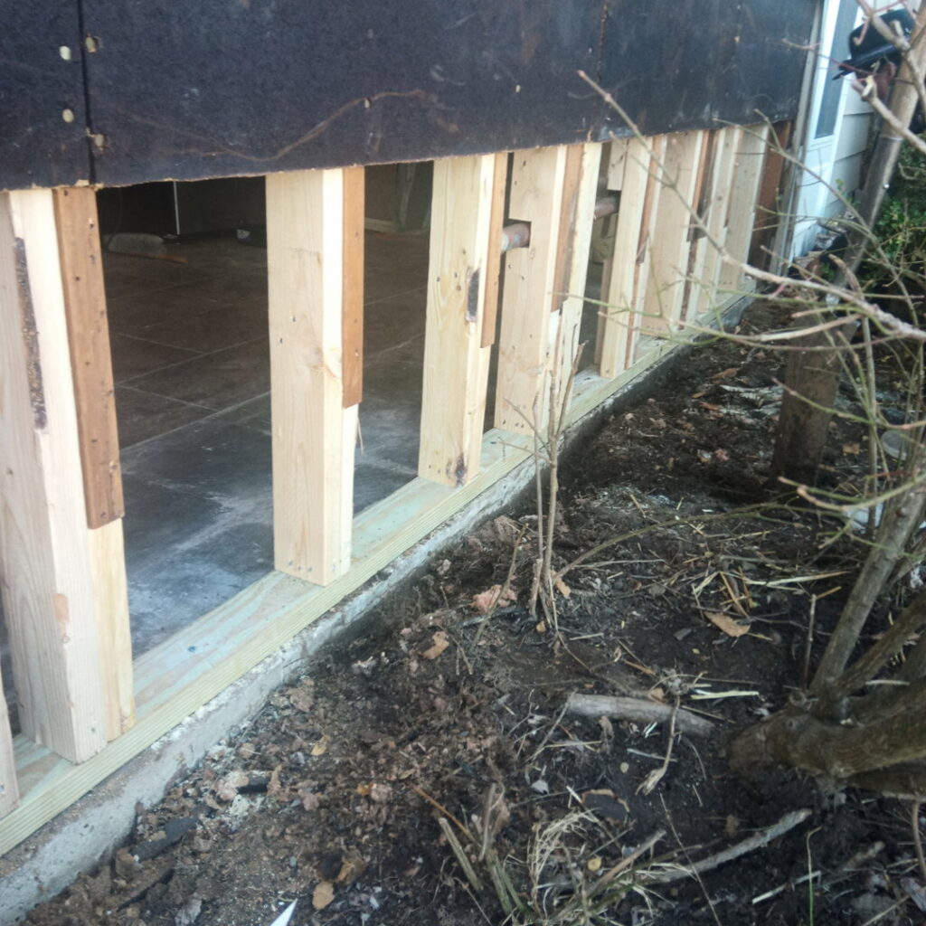An interior view of a room with exposed wooden studs, indicating a demolition or restoration phase after water damage, handled by Ciocca Cleaning & Restoration in Fort Wayne, IN.