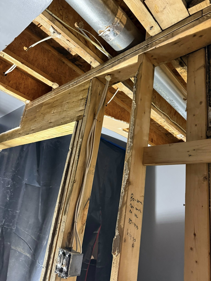 Exposed wall studs and ceiling joists during a water damage restoration project by Catalyst Restoration in Hagerstown, MD.
