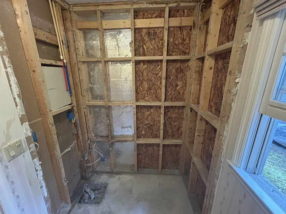 Exposed wall studs and insulation during water damage remediation by Coastal Site Services in Bluffton, SC.