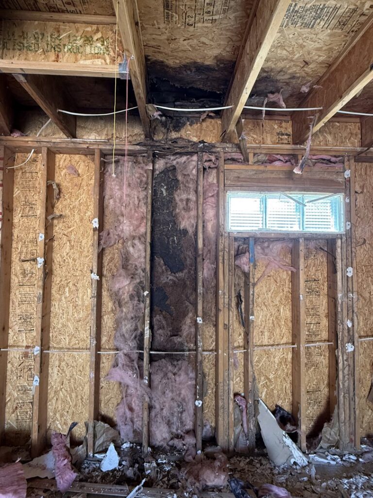 Exposed walls and insulation showing severe damage, likely from water or mold, by Western Skies Restoration in Gilbert, AZ.
