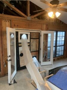 Exposed wooden beams and insulation visible during a renovation project by HaysCo Facilities Management, Inc. in Dothan, AL.