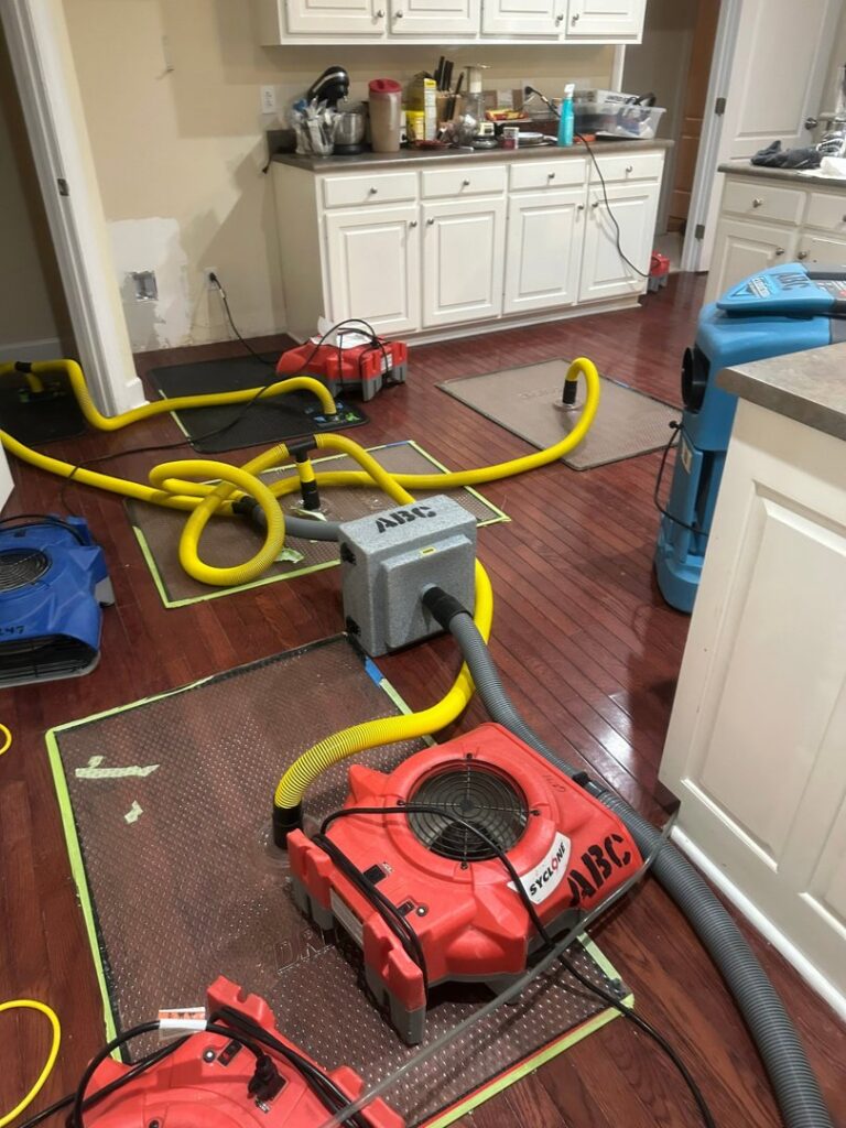 Extensive water damage drying equipment set up in a kitchen by ABC Cleaning and Restoration in Harvest, AL.