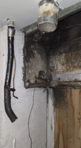 Extensive water damage and mold affecting a wall and exposed ductwork in a corner, requiring restoration by ABS Restoration Services, Inc. in North Little Rock, AR