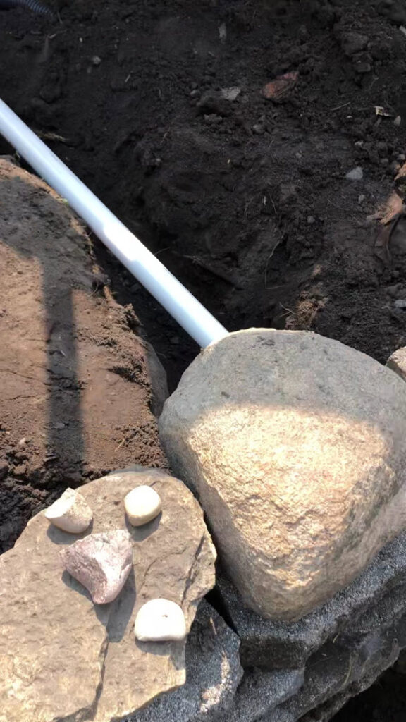 An exterior drainage pipe being installed next to a foundation by EverDry Toledo in Toledo, OH.