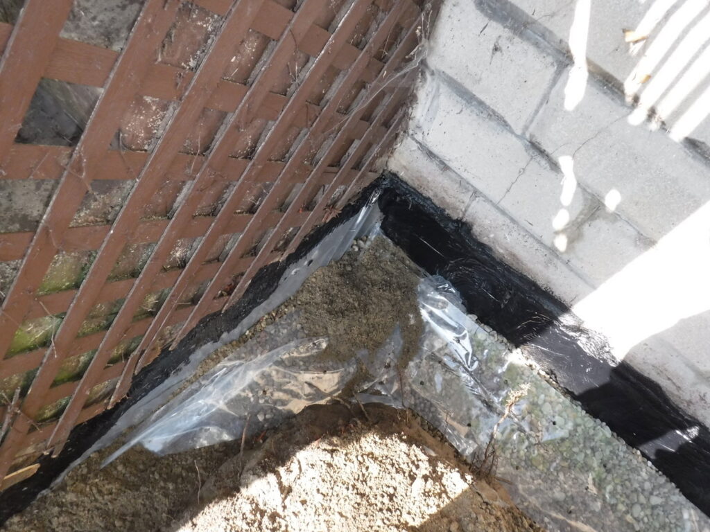 Exterior foundation with black waterproofing membrane and gravel installed by Waterdry Indiana in South Bend, IN