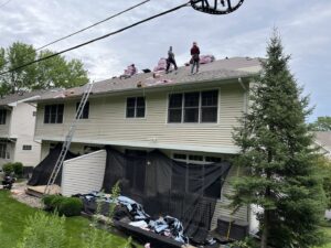 Exterior renovation in progress on a residential home, showing siding and roofing work by Archcraft Exteriors in South Saint Paul, MN.