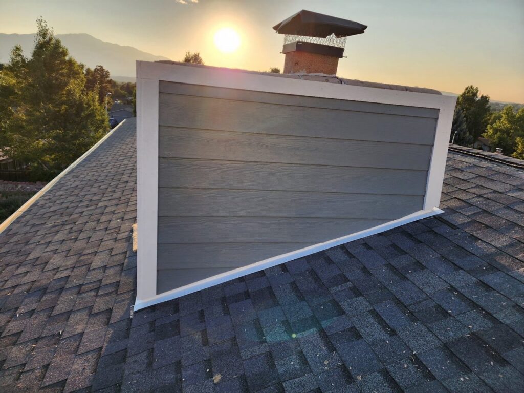 Completed siding installation on a residential chimney, showcasing quality work by EZ General Construction in Colorado Springs, CO.