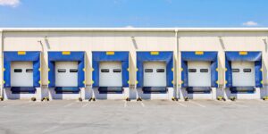 Five commercial loading dock doors at a business facility serviced by Pioneer Overhead Door, Inc in Las Vegas, NV.