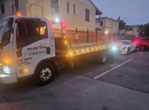 Orellanas Towing & Junk Car flatbed tow truck with its bed lowered, ready for a towing service in Los Angeles, CA.