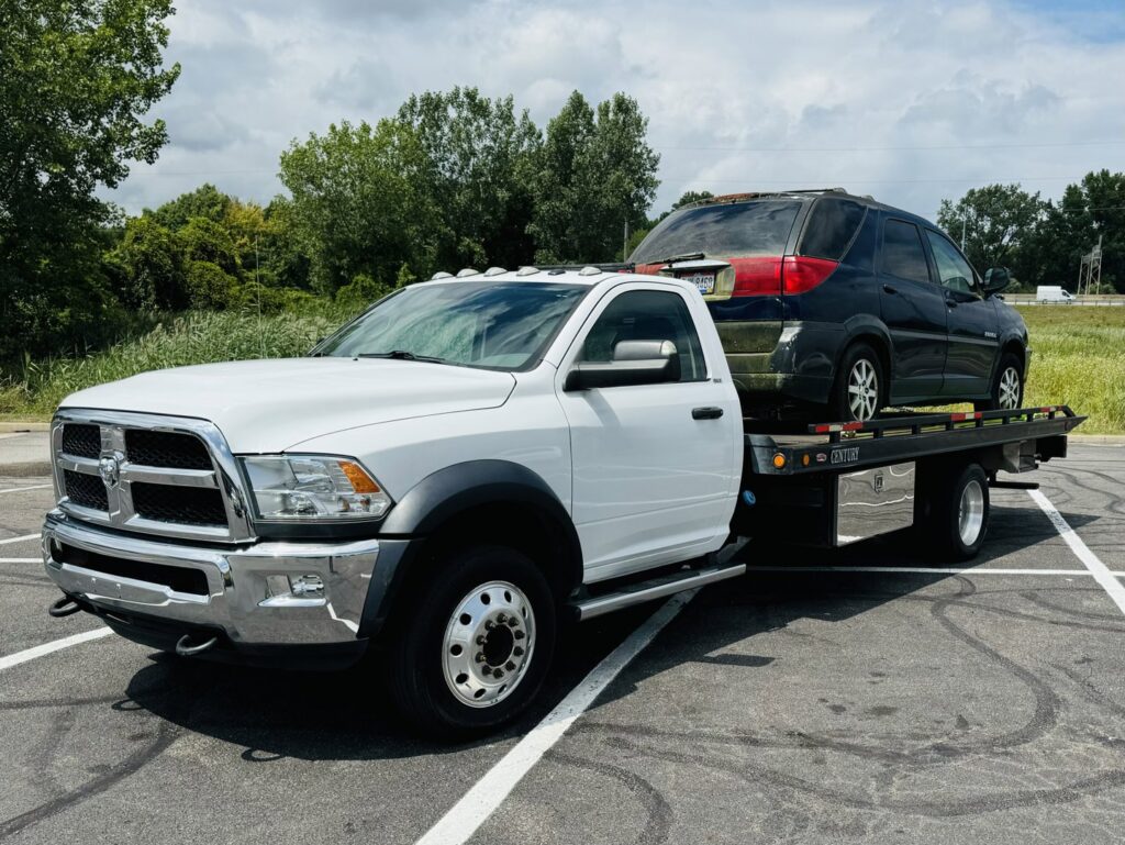 A flatbed tow truck from Av towing llc transporting a black SUV in Cleveland, OH.