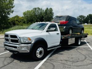 A flatbed tow truck from Av towing llc transporting a black SUV in Cleveland, OH.