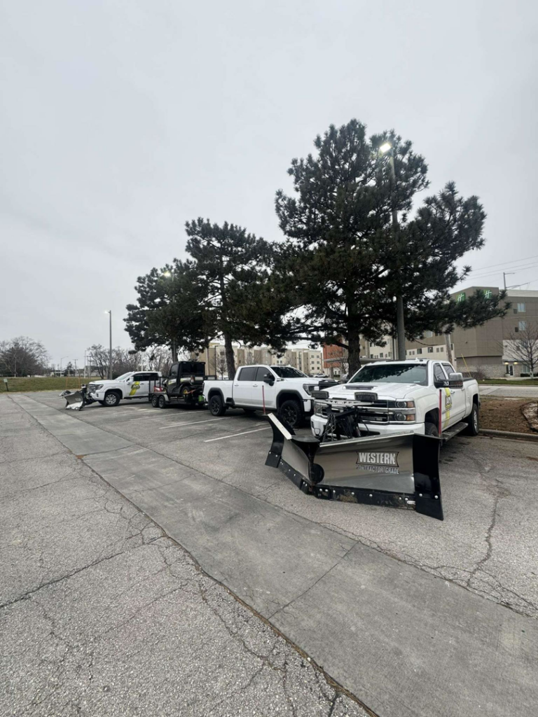 A fleet of snow plow trucks ready for service by AM Snow Removal & Lawn Care Services in Ankeny, IA.
