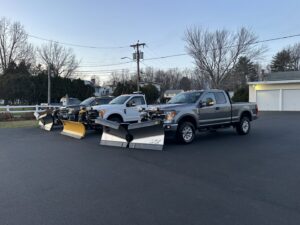 A fleet of three snow plow trucks ready for service from M.J.D Landscape Solutions, LLC in West Hartford, CT.