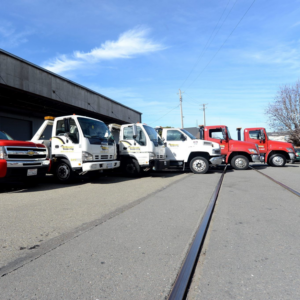 A fleet of various tow trucks lined up, ready for service at Emergency Towing Sacramento, CA.