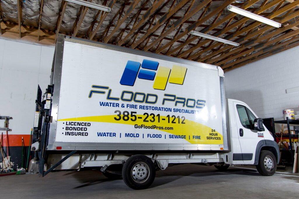A Flood Pros Water & Fire Restoration Specialist truck parked inside a facility in Sandy, UT.