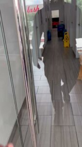 Flooded hallway with a wet floor sign and drying equipment for water damage cleanup by 1st Response Emergency Repairs, LLC in Scott, LA.