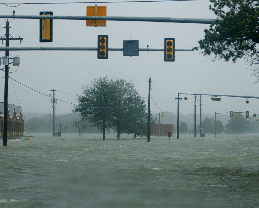 A street completely submerged in floodwater after a storm, indicating severe water damage needing Emergency Response Services Inc. in Warren, MI
