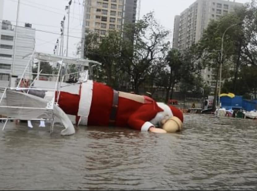 Floodwaters on a city street with a large inflatable Santa, showing water damage Pruden Restoration handles in Springdale, AR.