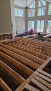 Workers replacing floor joists after significant water damage, showcasing remediation services by Coastal Site Services in Bluffton, SC.