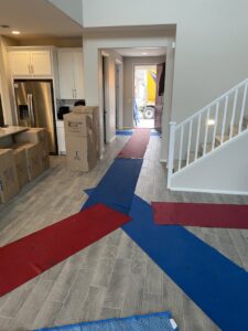 Floor protection laid out in a home with moving boxes and a truck visible, showing a move in progress by Moving Marvels in Tucson, AZ.