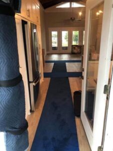 Blue moving blankets laid out on the floor of a home to protect surfaces during a move by Miracle Movers of Charleston, SC in Summerville, SC.