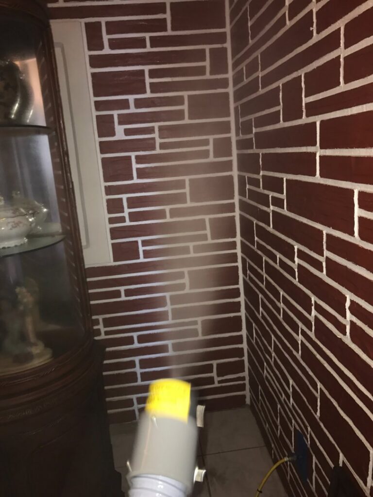 A fogging machine applying treatment to a wall, a common step in water damage restoration by Southcoast Cleaning Solutions & Restoration in Fall River, MA.