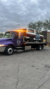 A two-tone Ford Bronco being transported on a flatbed tow truck by P&A towing & transport Llc in Phoenix, AZ