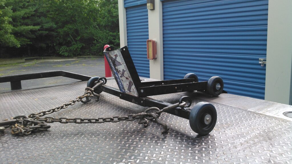 A forklift being transported on a flatbed tow truck by Baltimore Towing Service LLC in Owings Mills, MD.