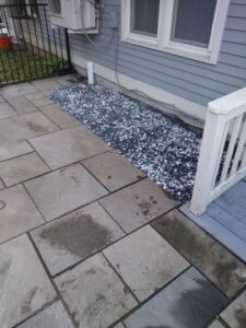 A finished foundation drainage system with a decorative gravel bed by EFFECTIVE WATERPROOFING in Worcester, MA.