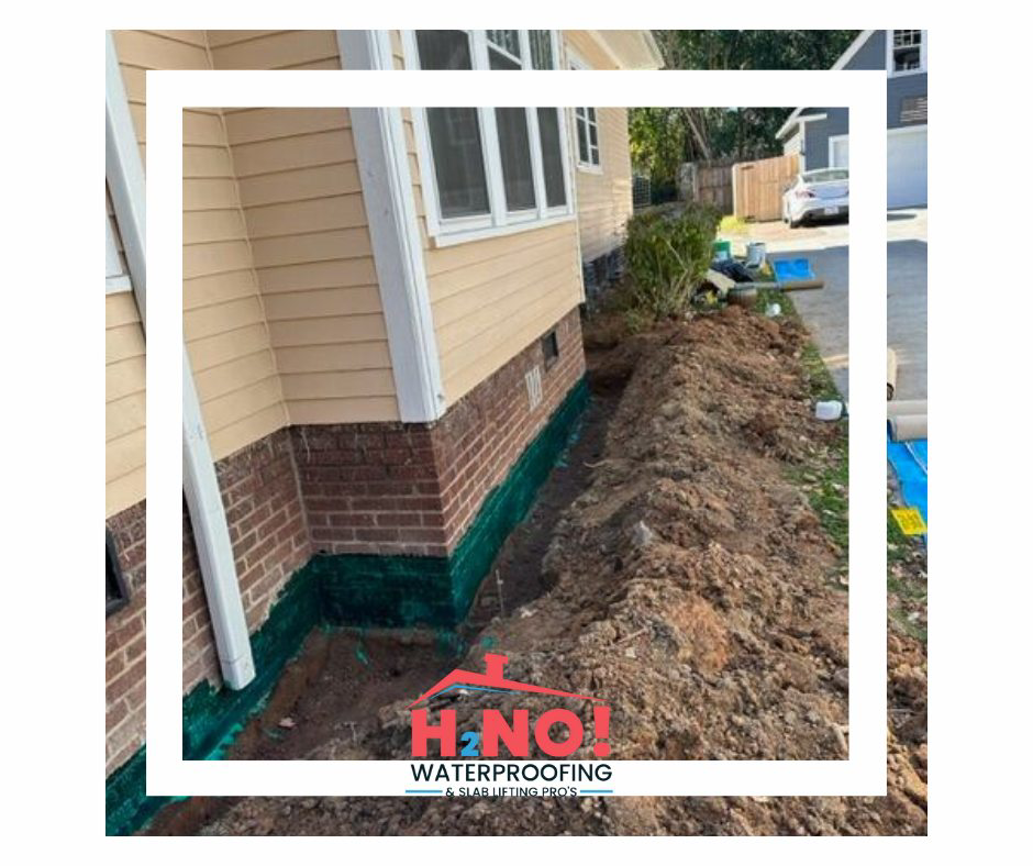 A house foundation with a green waterproofing membrane applied during a waterproofing job by HNO Waterproofing & Slab Lifting Pros in Concord, NC.