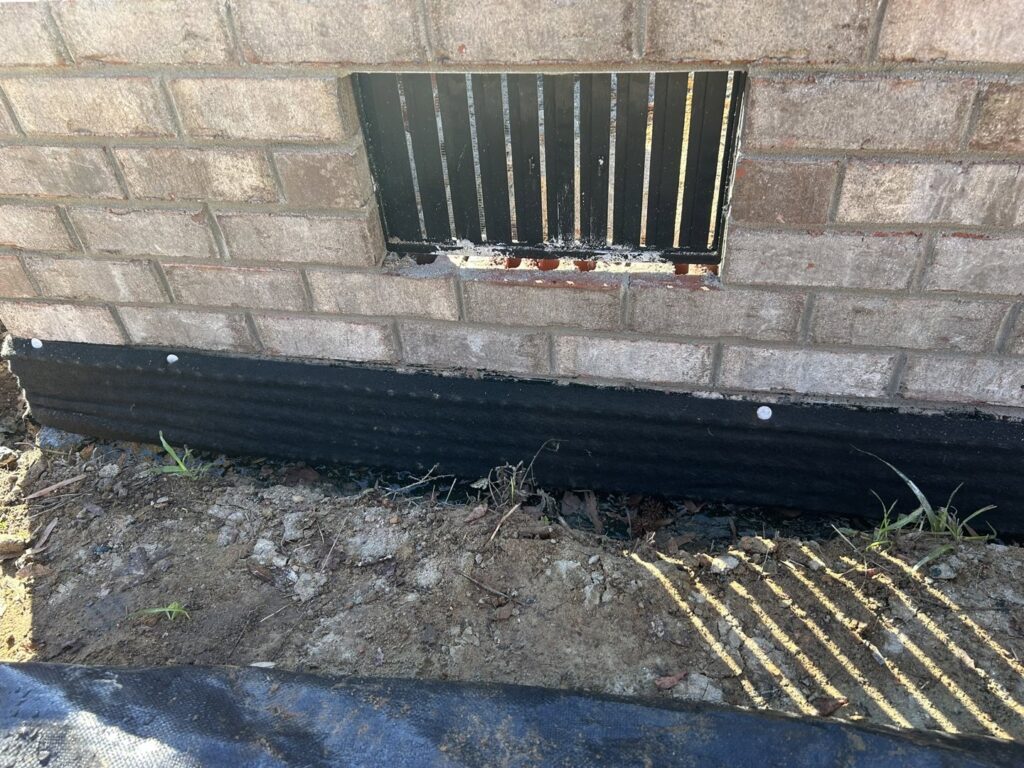 A foundation wall with a black waterproofing membrane installed by Wetlock Waterproofing in Rock Hill, SC.