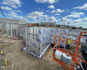 New construction foundation wall wrapped in waterproofing material by Proshield Waterproofing & Restoration in Overland Park, KS