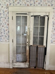 French doors showing severe water damage and peeling paint, requiring restoration from Gold Star Services LLC in Newark, DE