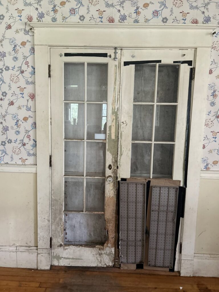 French doors showing severe water damage and peeling paint, requiring restoration from Gold Star Services LLC in Newark, DE