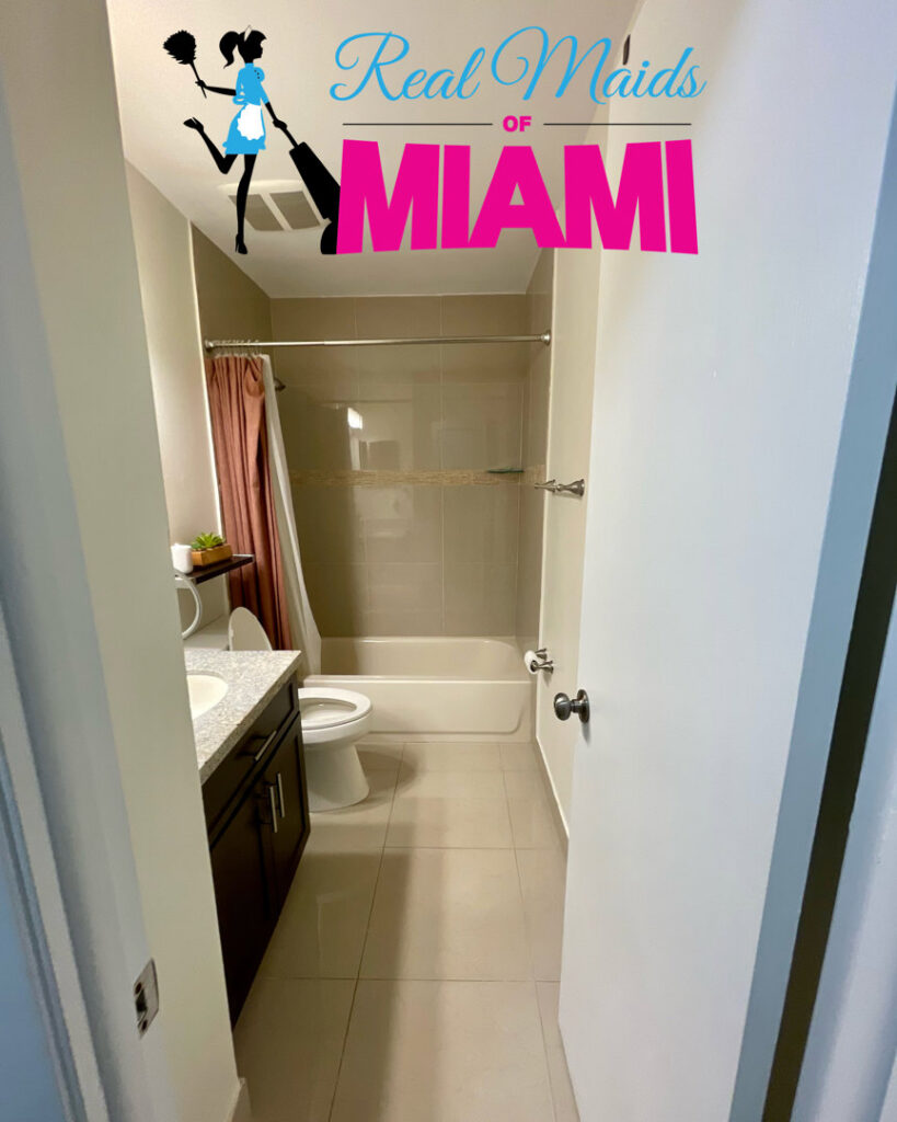 A freshly cleaned bathroom with a sparkling toilet and shower area by Real Maids of Miami, LLC in Miami, FL.