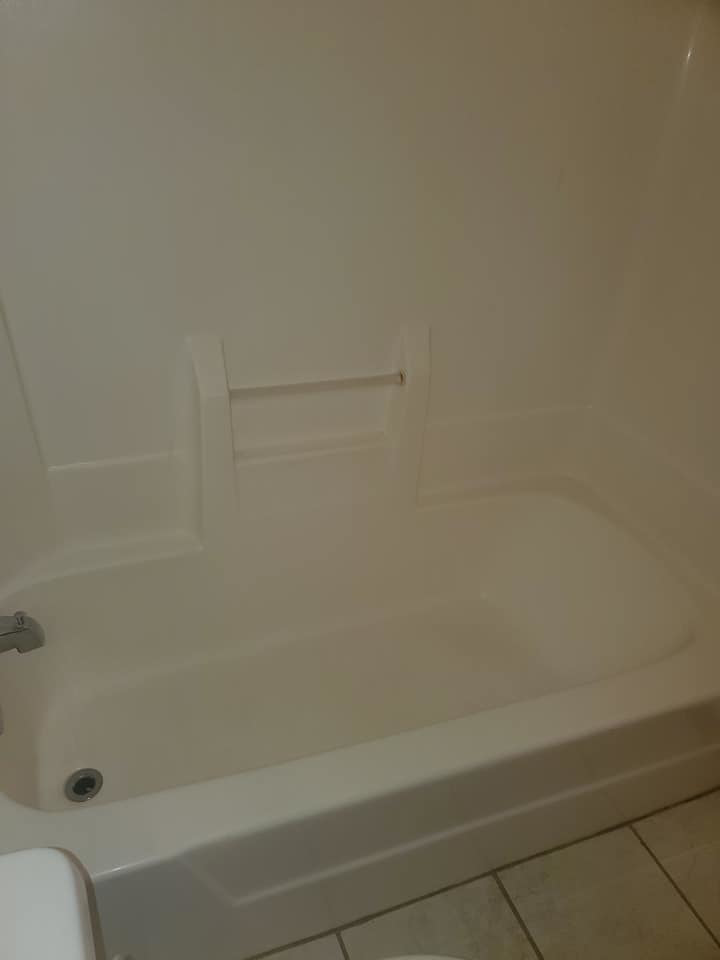 A freshly cleaned white bathroom tub, showcasing excellent results from Tip Top Cleaning in Champaign, IL.