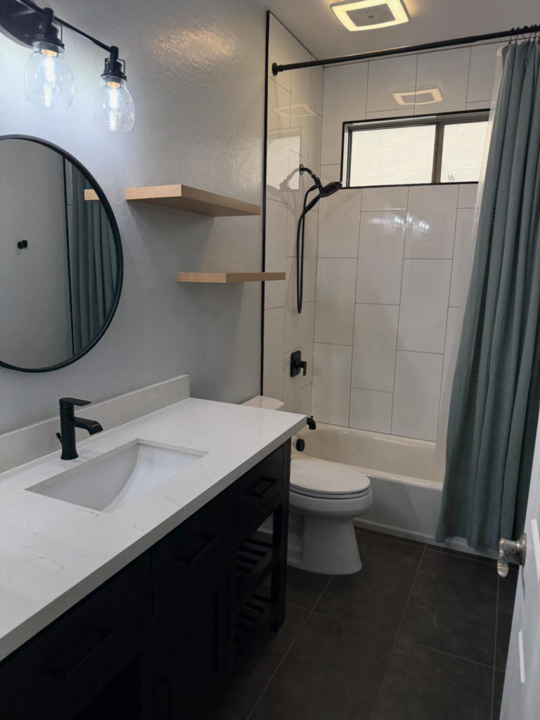 A freshly cleaned bathroom featuring a vanity, toilet, and shower by ClutterGone in Surprise, AZ.