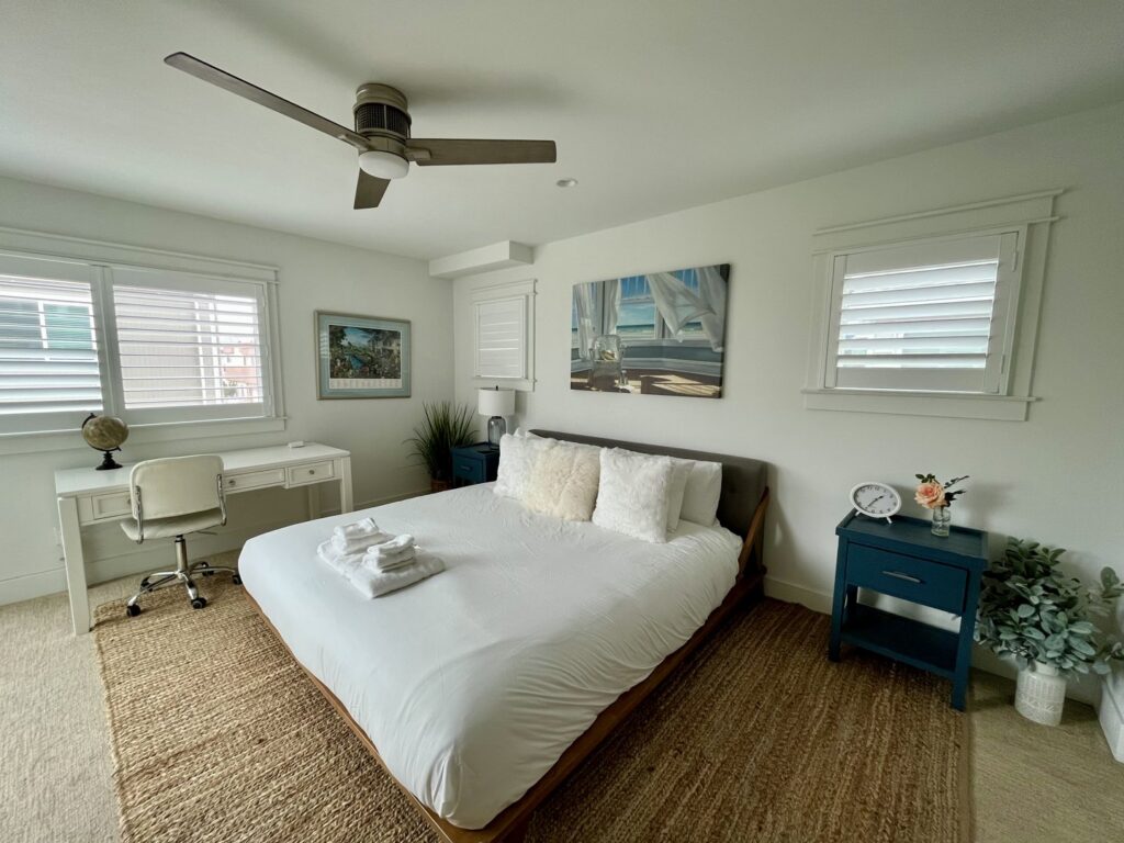 A freshly cleaned bedroom with neatly folded towels on the bed, a service provided by Glisten Co Cleaning Service in Worcester, MA.