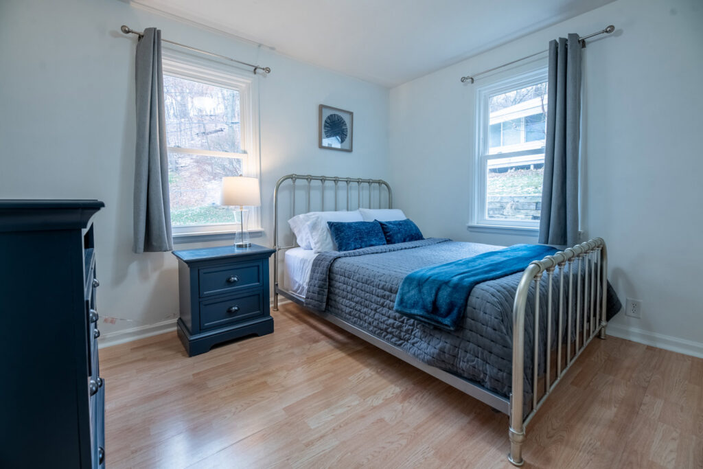 A freshly cleaned bedroom with a neatly made bed and tidy furniture, showcasing the quality service of Peoria Cleaning Pros, LLC in East Peoria, IL.