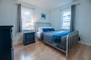 A freshly cleaned bedroom with a neatly made bed and tidy furniture, showcasing the quality service of Peoria Cleaning Pros, LLC in East Peoria, IL.