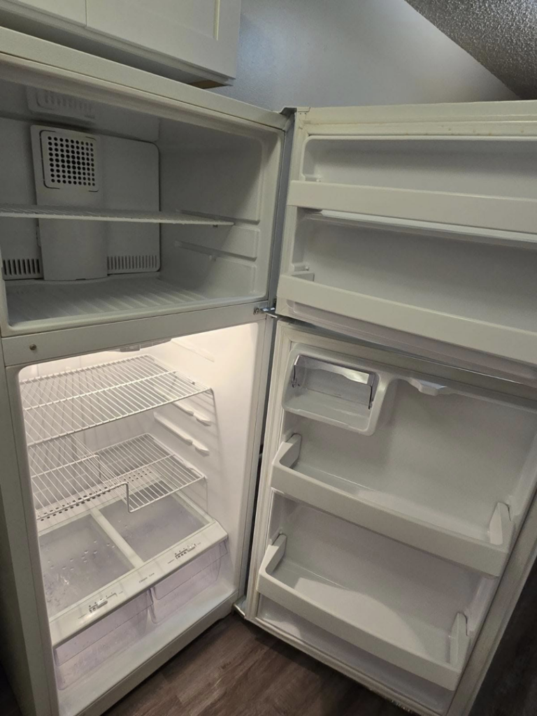A freshly cleaned and empty refrigerator, showcasing deep cleaning by Arroyos Cleaning LLC in Fort Myers, FL.