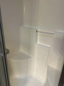 A freshly cleaned shower stall, spotless after service from Crystal's Small Town Cleaning Company, LLC in Oelwein, IA.
