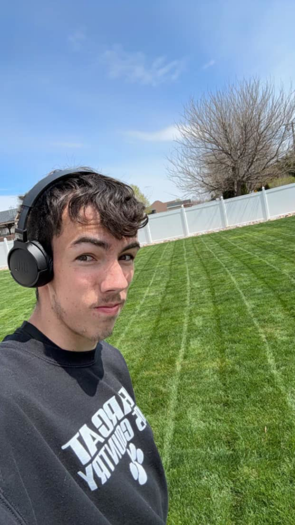 A perfectly mowed lawn with crisp stripes, showcasing the quality work of Winter/Green Solutions LLC in Kearney, NE.