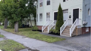 A freshly mulched garden bed and a neatly mowed lawn by Steele Lawns in Portland, ME.