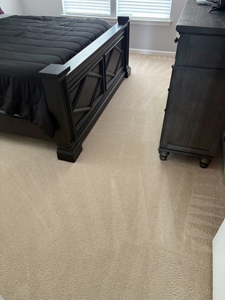 A freshly vacuumed bedroom carpet with clear lines by Five Star Cleaning Service in Pasadena, MD.