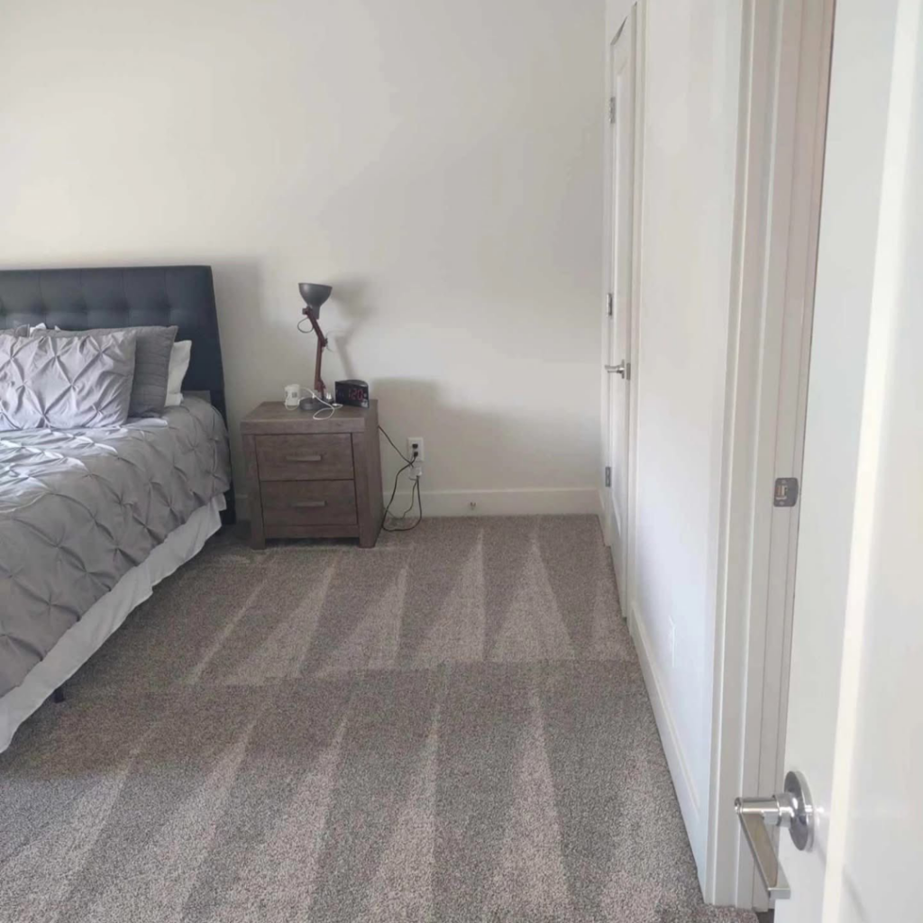 A freshly vacuumed bedroom carpet with clear lines, showcasing cleaning work by Mighty Mess Maid in Elizabethtown, KY.