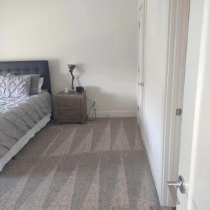A freshly vacuumed bedroom carpet with clear lines, showcasing cleaning work by Mighty Mess Maid in Elizabethtown, KY.